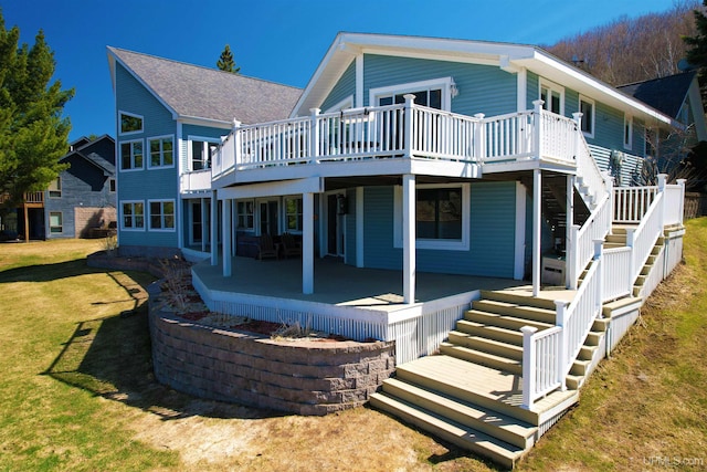 18918 Canal Rd, Houghton, MI 49931 - back of property featuring stairway, a lawn, a deck, and a patio area