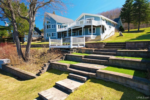 18918 Canal Rd, Houghton, MI 49931 - view of front of property with stairway, a front yard, and a wooden deck