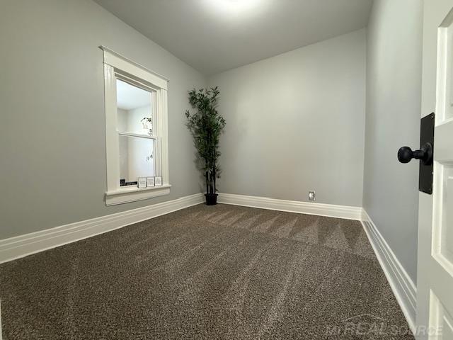 1416 Kearney St, Port Huron, MI 48060 - spare room featuring dark colored carpet and baseboards