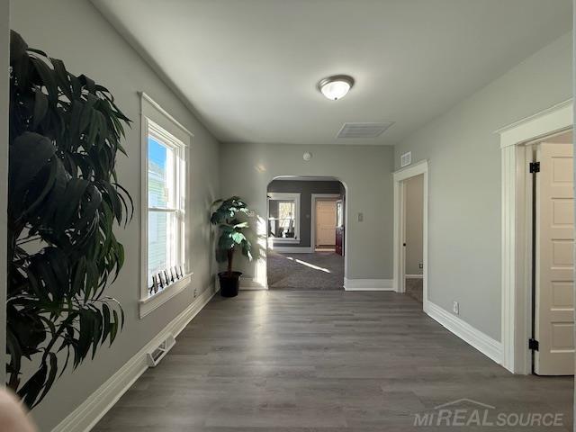 1416 Kearney St, Port Huron, MI 48060 - corridor featuring arched walkways, baseboards, and wood finished floors
