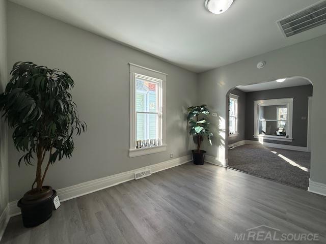 1416 Kearney St, Port Huron, MI 48060 - unfurnished room with arched walkways, healthy amount of natural light, and baseboards