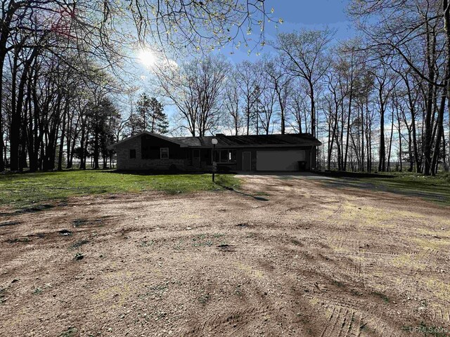 9014 Stagecoach Q.5 Ave, Gladstone, MI 49837 - view of front facade featuring a garage and dirt driveway