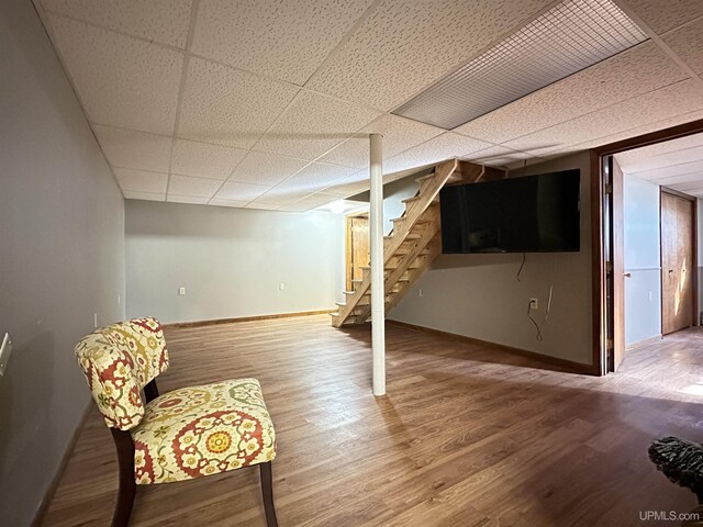 9014 Stagecoach Q.5 Ave, Gladstone, MI 49837 - finished below grade area with a paneled ceiling, baseboards, stairway, and wood finished floors