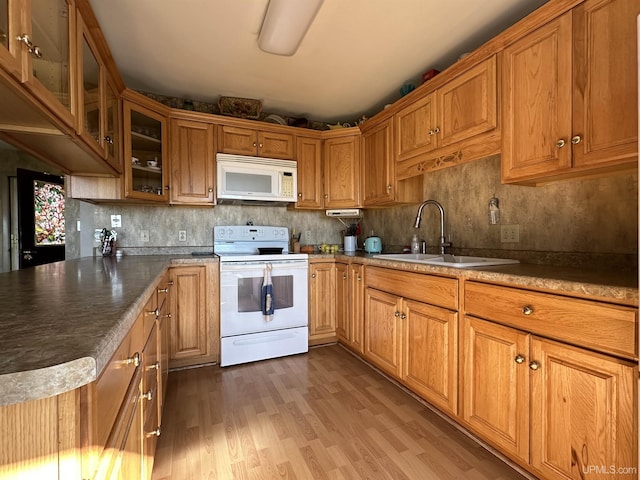 9014 Stagecoach Q.5 Ave, Gladstone, MI 49837 - kitchen with white appliances, a sink, wood finished floors, and brown cabinets