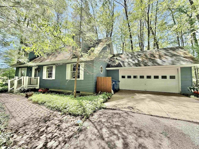 555 W Saxton Rd, Sanford, MI 48657 - view of home's exterior with driveway and an attached garage