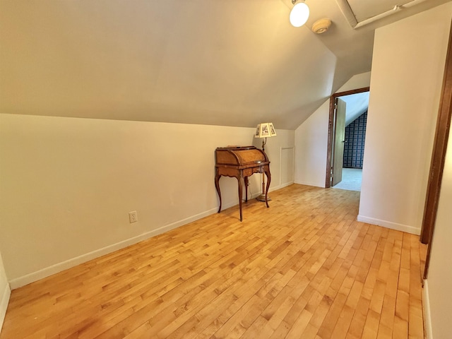 555 W Saxton Rd, Sanford, MI 48657 - additional living space featuring light wood finished floors, vaulted ceiling, and baseboards