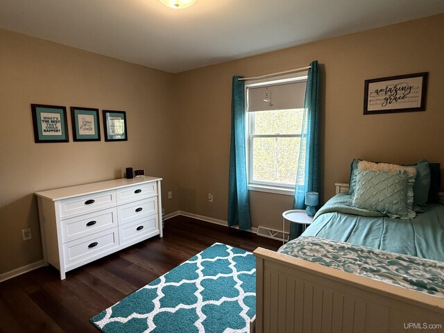 1300 W Sharon Ave, Houghton, MI 49931 - bedroom featuring dark wood-style flooring and baseboards
