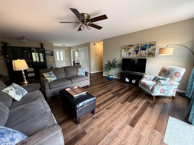 1300 W Sharon Ave, Houghton, MI 49931 - living room featuring wood finished floors, baseboards, and a ceiling fan