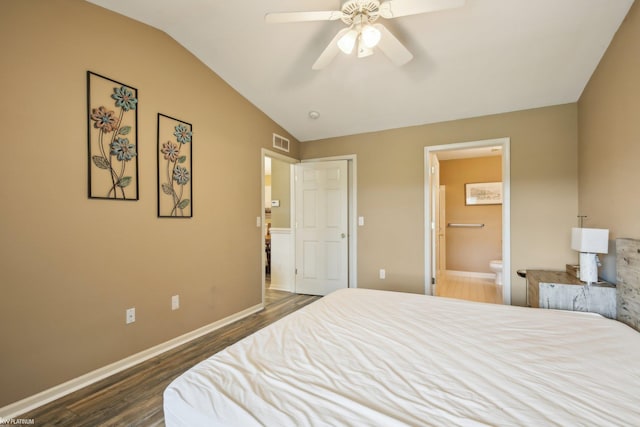 bedroom with dark wood-type flooring, lofted ceiling, ensuite bath, baseboards, and a ceiling fan
