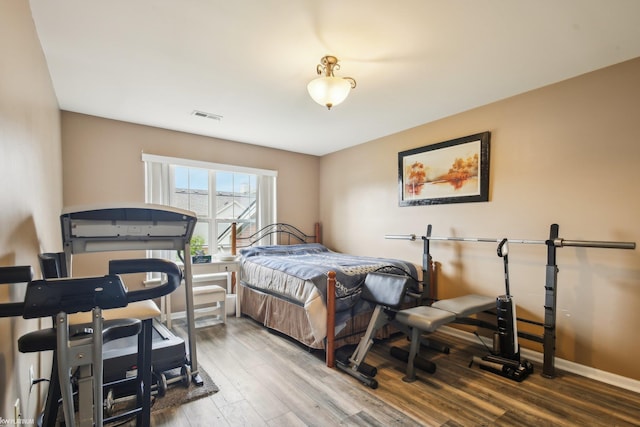 bedroom featuring wood finished floors and baseboards
