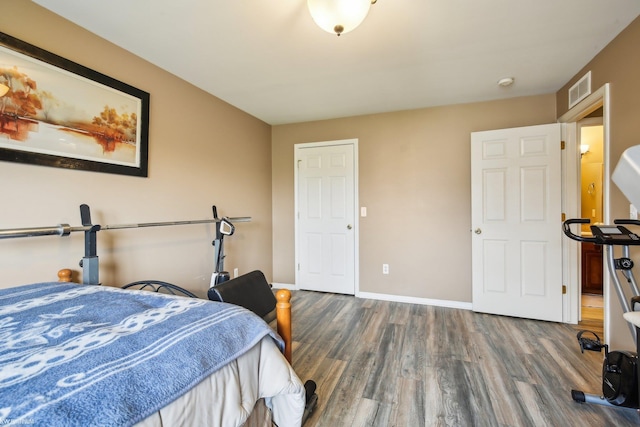 bedroom featuring wood finished floors and baseboards