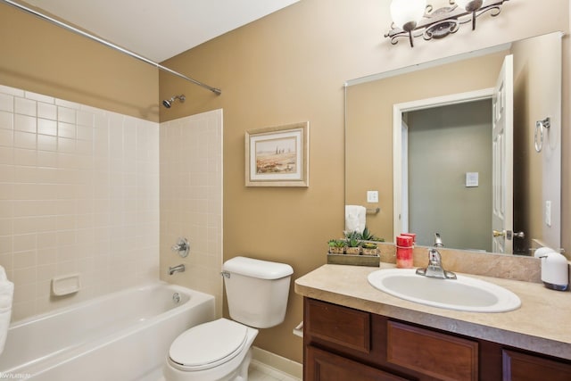 full bathroom featuring toilet, vanity, bathtub / shower combination, and baseboards