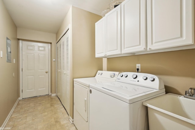 clothes washing area with washer and dryer, baseboards, cabinet space, electric panel, and stone finish floors