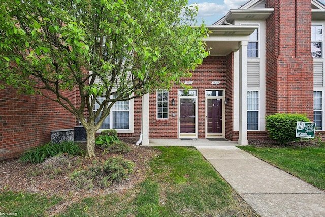 property entrance featuring brick siding