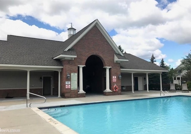 community pool with a patio area