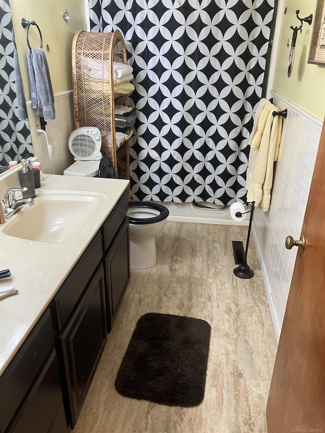63150 Mound Rd, Washington Twp, MI 48095 - full bath featuring a shower, toilet, vanity, tile walls, and wainscoting