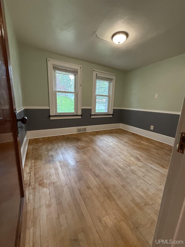 404 W Ludington St, Iron Mountain, MI 49801 - empty room with wood-type flooring