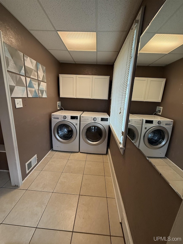 404 W Ludington St, Iron Mountain, MI 49801 - laundry room with washer and dryer, cabinet space, light tile patterned floors, and baseboards