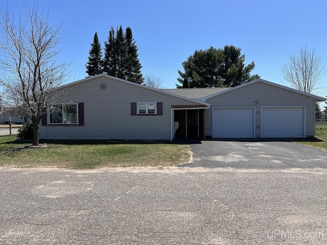 99 N Mitchell St, Gwinn, MI 49841 - ranch-style home featuring an attached garage, driveway, and a front yard