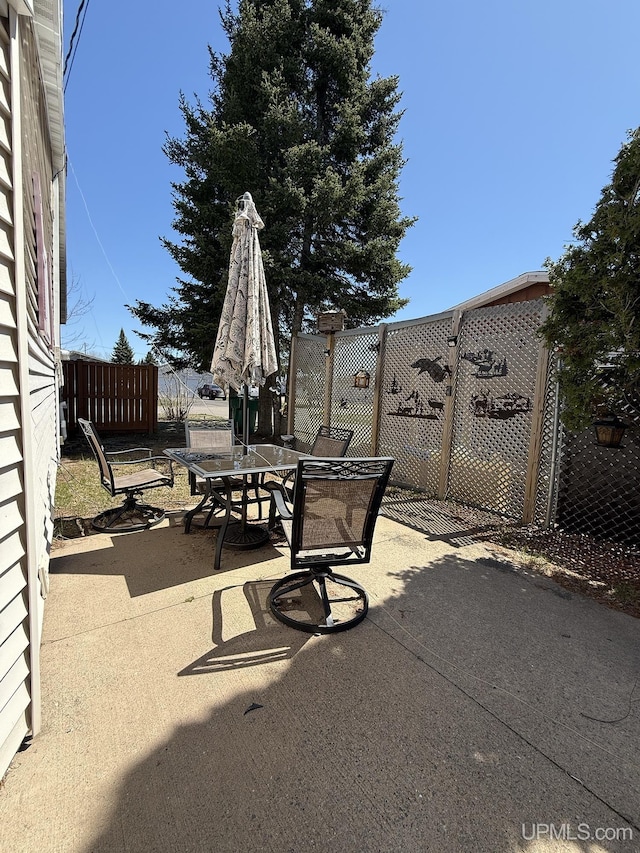 99 N Mitchell St, Gwinn, MI 49841 - view of patio / terrace featuring fence and outdoor dining space