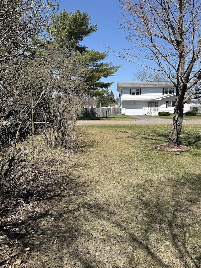 99 N Mitchell St, Gwinn, MI 49841 - view of yard with an attached garage