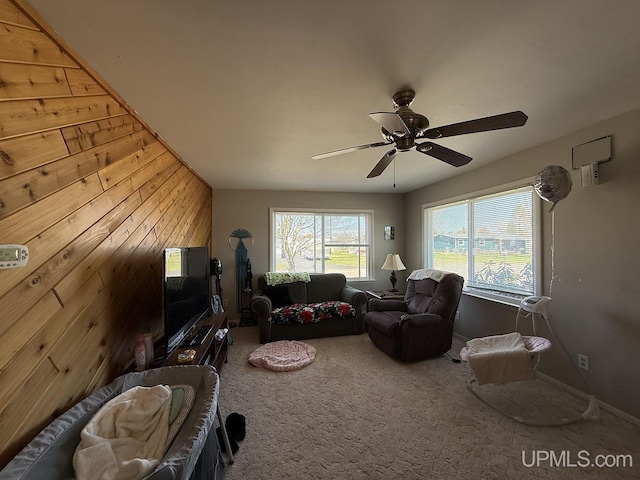 99 N Mitchell St, Gwinn, MI 49841 - carpeted living room featuring ceiling fan and wooden walls