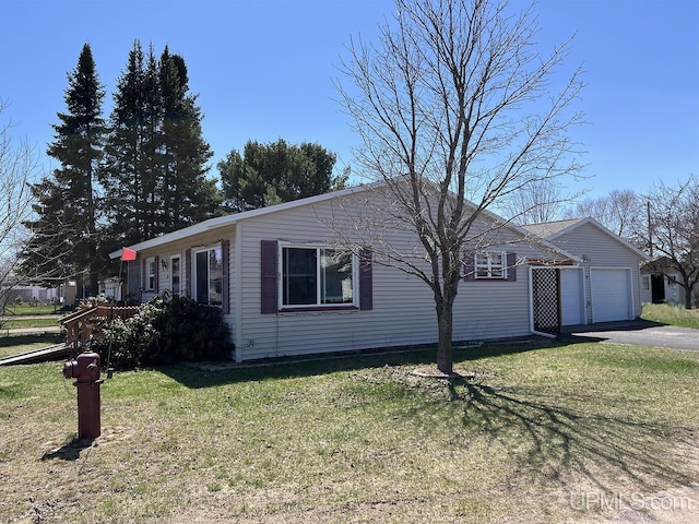 99 N Mitchell St, Gwinn, MI 49841 - single story home featuring an attached garage, driveway, and a front lawn