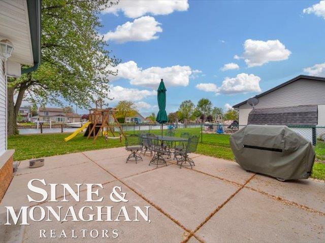 view of patio featuring a playground and grilling area