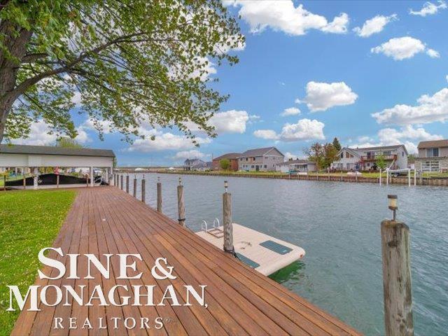 dock area featuring a water view and a residential view