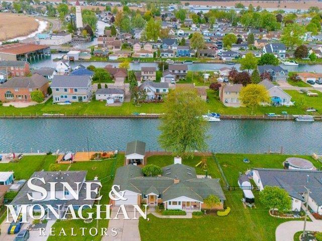 view of property location featuring nearby suburban area and a large body of water