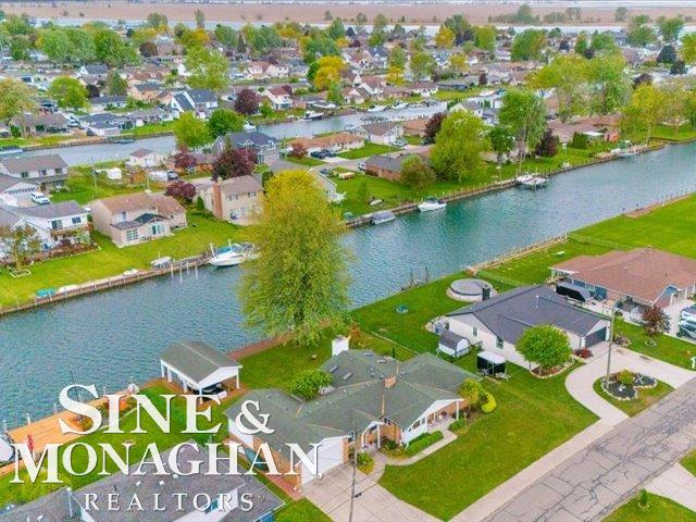 aerial perspective of suburban area featuring a large body of water