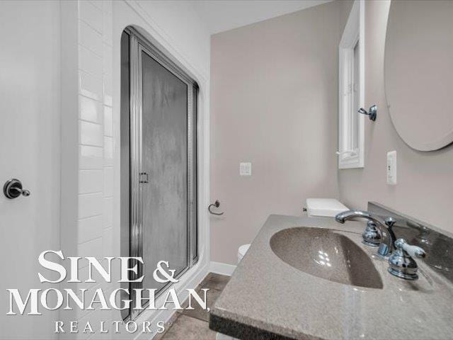 bathroom with a stall shower and vanity
