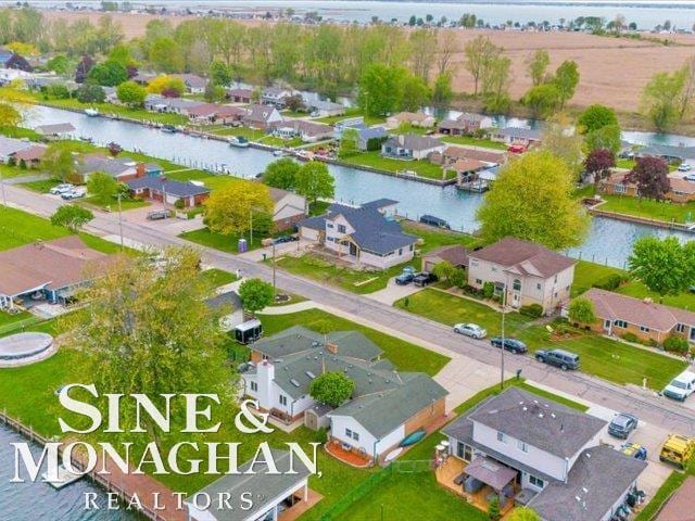 aerial perspective of suburban area featuring a large body of water