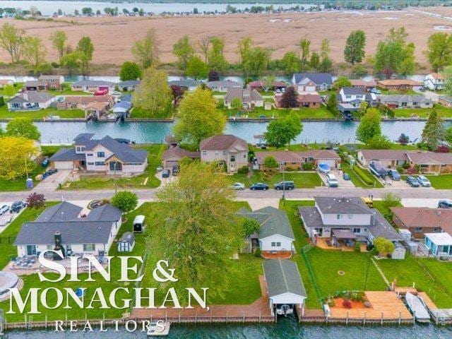 aerial view of residential area featuring a large body of water