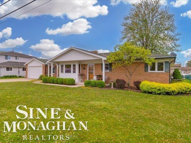 ranch-style home featuring a front yard, concrete driveway, brick siding, a garage, and a porch