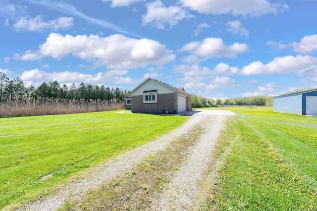 view of dirt / gravel driveway with a rural view