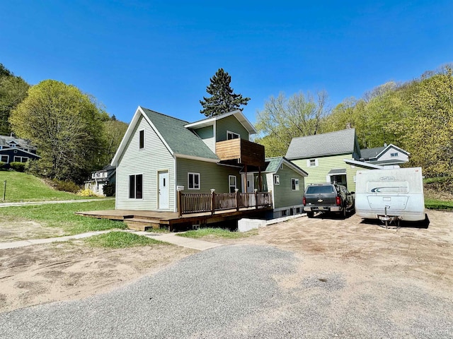 518 Lynn St, Munising, MI 49862 - view of front of property featuring a deck, a balcony, and roof with shingles