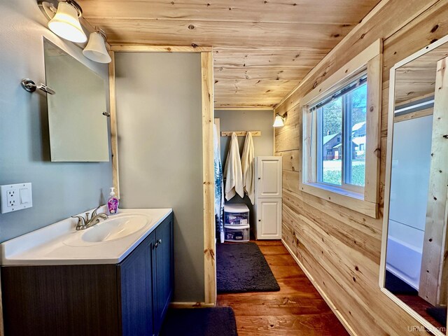 518 Lynn St, Munising, MI 49862 - bathroom with wood ceiling, wood finished floors, vanity, and wood walls