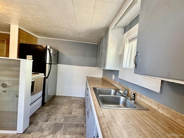 518 Lynn St, Munising, MI 49862 - kitchen with a sink, electric range, and freestanding refrigerator
