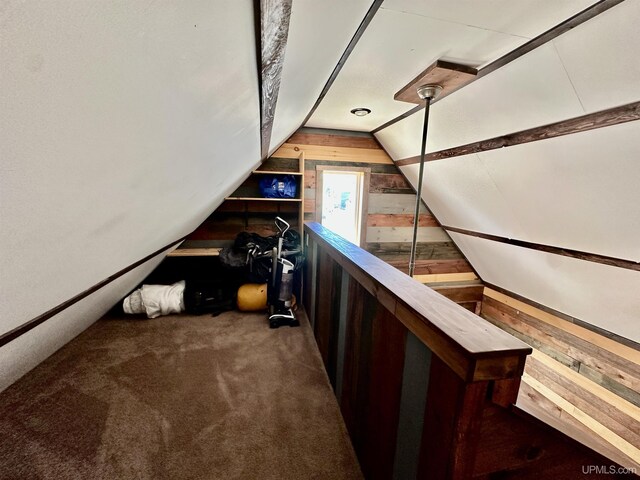 518 Lynn St, Munising, MI 49862 - stairs with wood walls, lofted ceiling, and carpet flooring