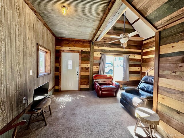 518 Lynn St, Munising, MI 49862 - living room featuring wood walls, plenty of natural light, carpet floors, and a ceiling fan