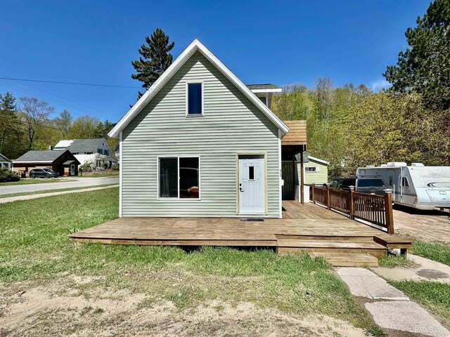 518 Lynn St, Munising, MI 49862 - back of house featuring a deck and a lawn