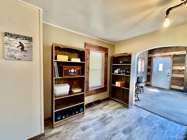 518 Lynn St, Munising, MI 49862 - entryway featuring arched walkways, wood finished floors, baseboards, and plenty of natural light