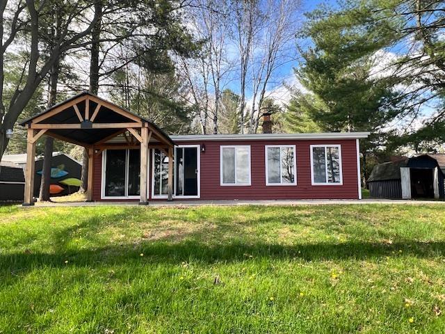 601 N Scott Dr, Farwell, MI 48622 - rear view of house featuring a chimney and a yard