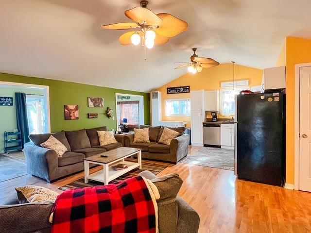 601 N Scott Dr, Farwell, MI 48622 - living area with light wood-style floors, a ceiling fan, and vaulted ceiling