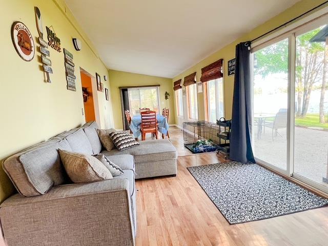 601 N Scott Dr, Farwell, MI 48622 - sunroom / solarium with healthy amount of natural light, vaulted ceiling, and wood finished floors