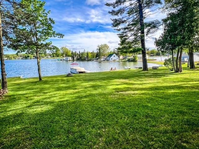 601 N Scott Dr, Farwell, MI 48622 - view of grassy yard with a water view and a dock