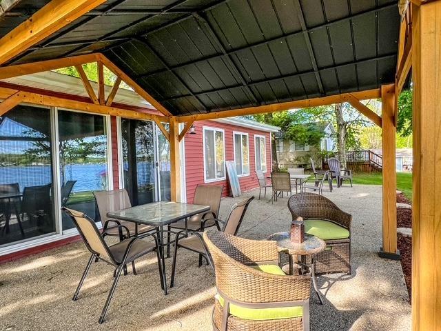 601 N Scott Dr, Farwell, MI 48622 - view of patio / terrace with outdoor dining space and an outdoor structure