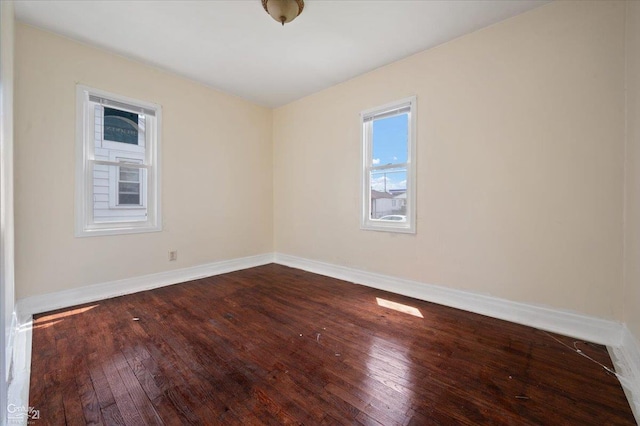7003 Paige Ave, Warren, MI 48091 - unfurnished room featuring healthy amount of natural light, dark wood-style floors, and baseboards