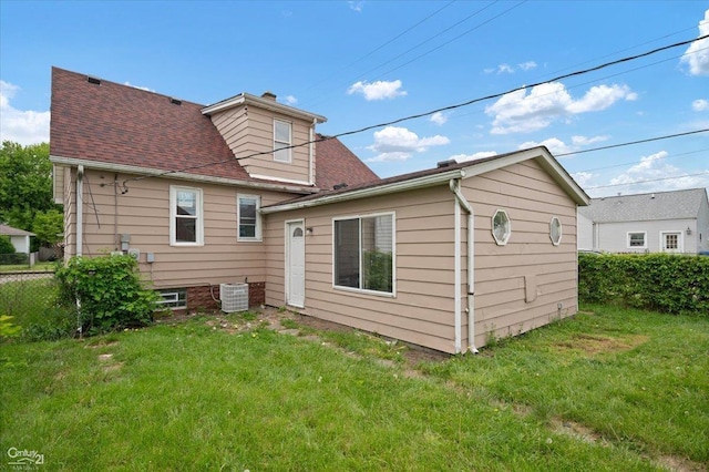 7003 Paige Ave, Warren, MI 48091 - back of house featuring central air condition unit, roof with shingles, and a chimney